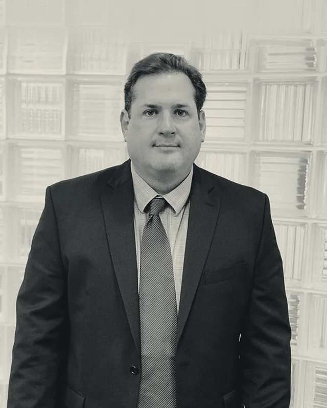 Douglas J. Phebus, partner at Arellano and Phebus, photographed against a light ground.