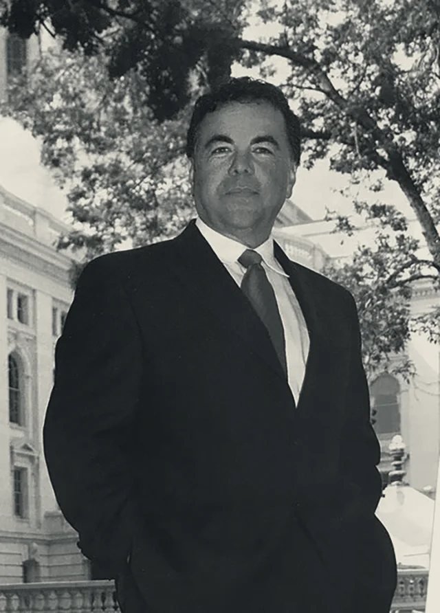Victor M. Arellano, partner at Arellano and Phebus, photographed against a dark ground.